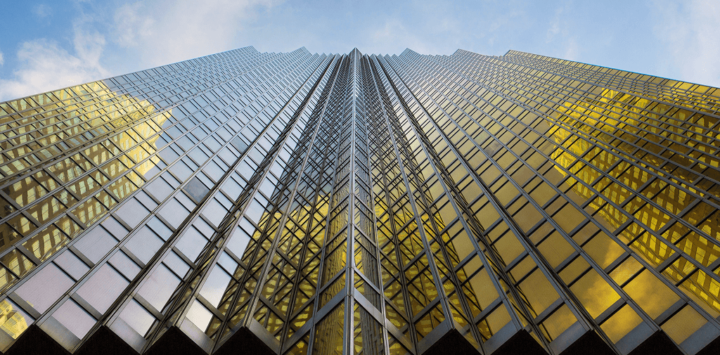 Towering geometric skyscraper with reflective golden windows